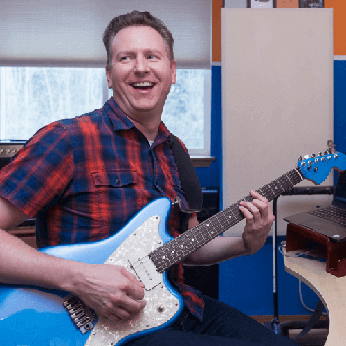 Rob, a real Breyanzi patient, with his guitar.